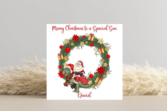 Santa riding a Dinosaur in a Wreath Christmas Card- Personalise with name and Relationship